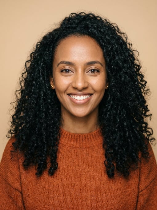 Professional studio headshot of a 26-year-old Ethiopian woman with long tight curls in black