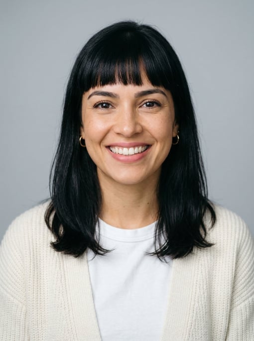 Professional studio headshot of a 32-year-old Brazilian woman with blunt bangs with shoulder-length