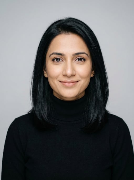 Professional studio headshot of a 33-year-old Pakistani woman with shoulder-length straight black ha