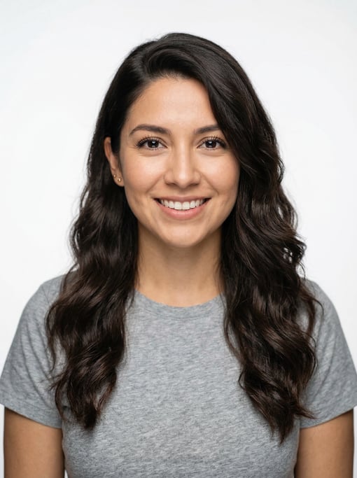 Professional studio headshot of a 28-year-old Mexican woman with a deep side part with long brown wa