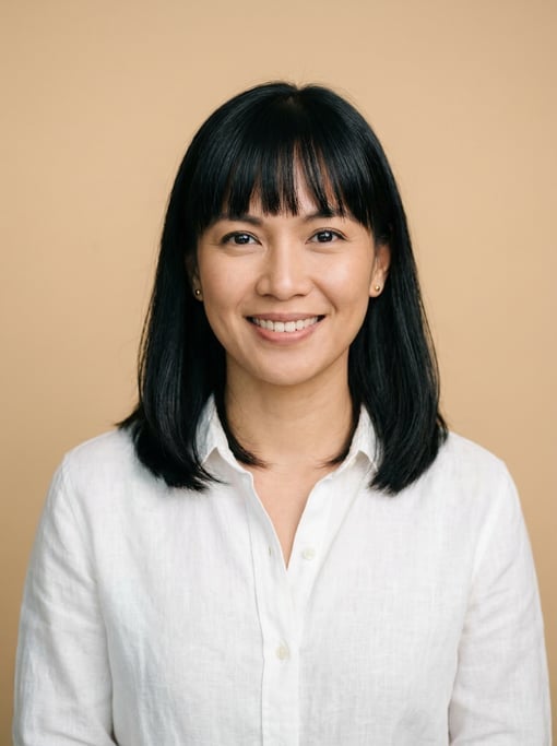 Professional studio headshot of a 36-year-old Filipino woman with blunt bangs with shoulder-length b