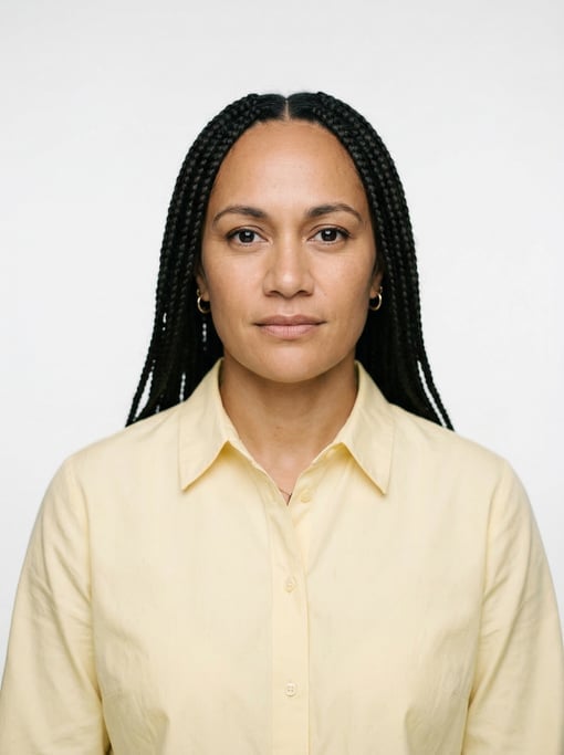 Professional studio headshot of a 37-year-old Maori woman with long box braids in black