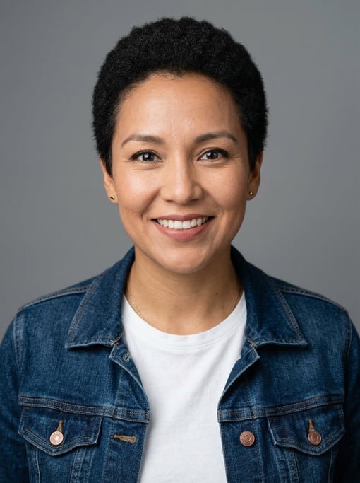 Professional studio headshot of a 34-year-old Native American woman with a short TWA hairstyle in bl