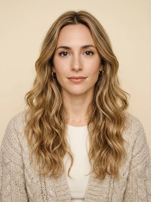 Professional studio headshot of a 27-year-old Argentinian woman with long wavy honey blonde hair