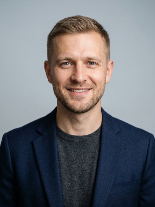 Professional studio headshot of a 31-year-old White Eastern European man with short cropped sandy br