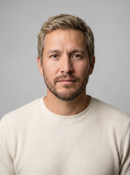Professional studio headshot of a 40-year-old Native American man with short dirty blonde hair