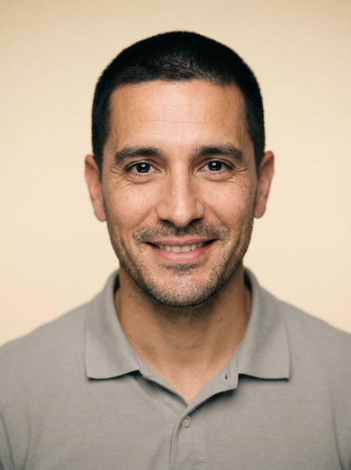 Professional studio headshot of a 39-year-old Argentinian man with a buzz cut in black