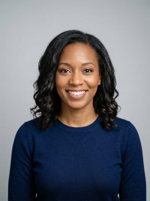 Professional studio headshot of a 34-year-old Black American woman with shoulder-length wavy dark ha