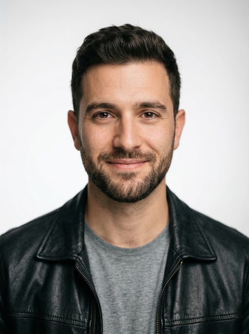 Professional studio headshot of a 26-year-old White Mediterranean man with a dark brown textured cro