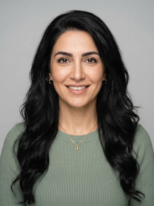 Professional studio headshot of a 39-year-old Persian woman with long wavy black hair