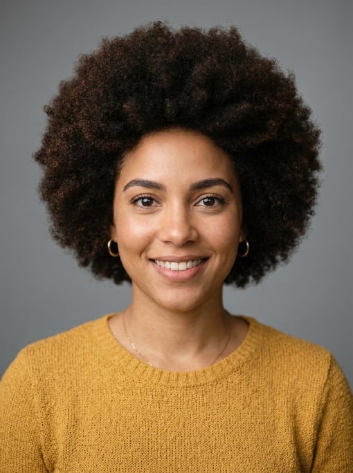Professional studio headshot of a 26-year-old Cuban woman with a natural afro in dark brown