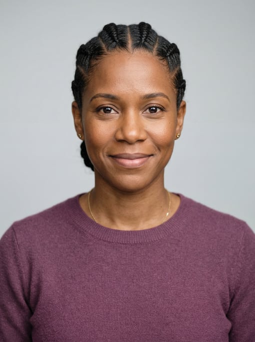 Professional studio headshot of a 37-year-old Dominican woman with cornrows pulled back neatly