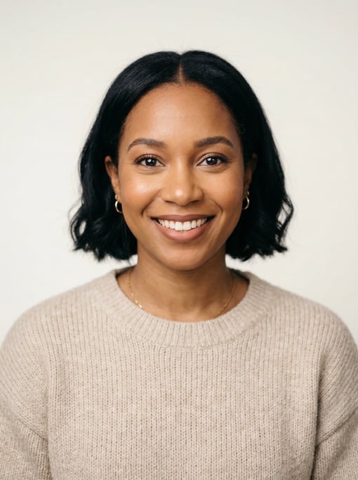 Professional studio headshot of a 29-year-old Black Caribbean woman with a chin-length bob in jet bl