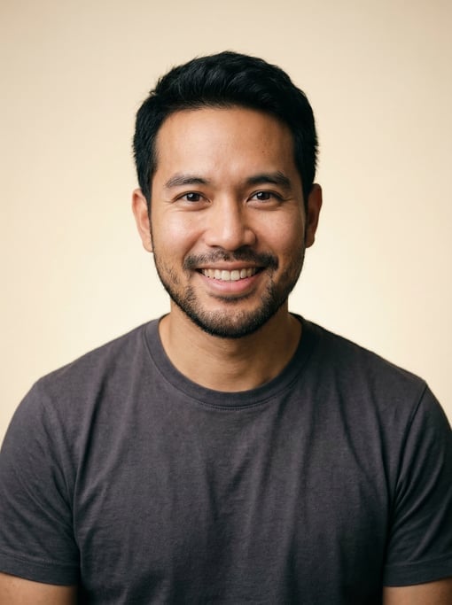 Professional studio headshot of a 31-year-old Thai man with short textured black hair