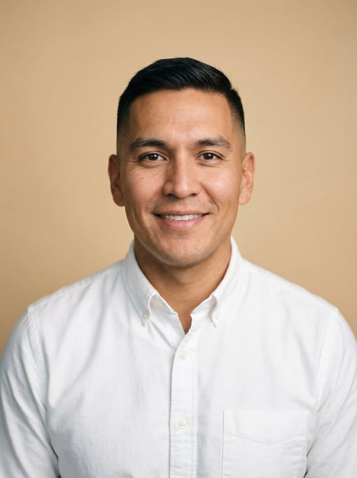 Professional studio headshot of a 30-year-old Native American man with a short clean fade