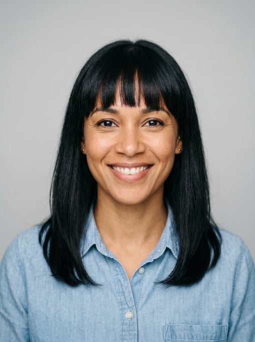Professional studio headshot of a 36-year-old mixed-race woman with blunt bangs with shoulder-length