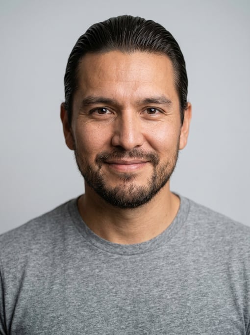 Professional studio headshot of a 36-year-old Native American man with a slicked-back style in dark