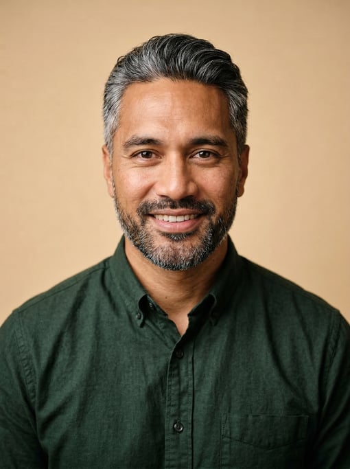 Professional studio headshot of a 31-year-old Pacific Islander man with silver-streaked dark hair co