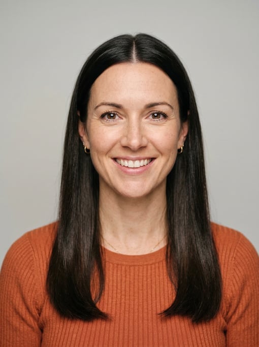 Professional studio headshot of a 38-year-old White British woman with long straight dark brown hair