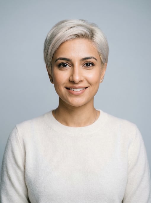 Professional studio headshot of a 33-year-old Pakistani woman with a short pixie cut in platinum blo