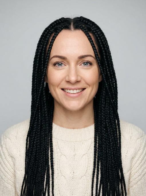 Professional studio headshot of a 34-year-old White European woman with long box braids in black
