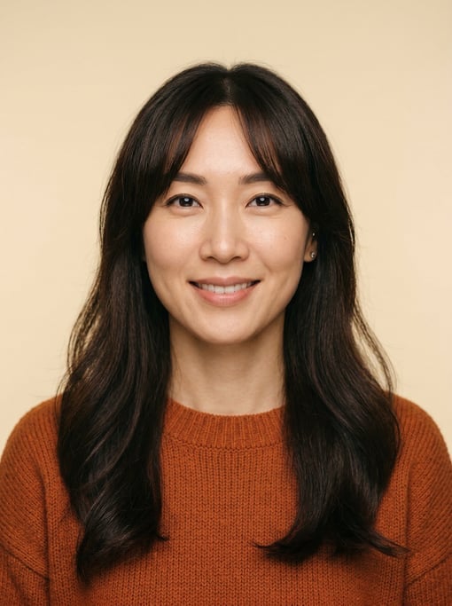 Professional studio headshot of a 37-year-old Korean woman with curtain bangs with long dark hair
