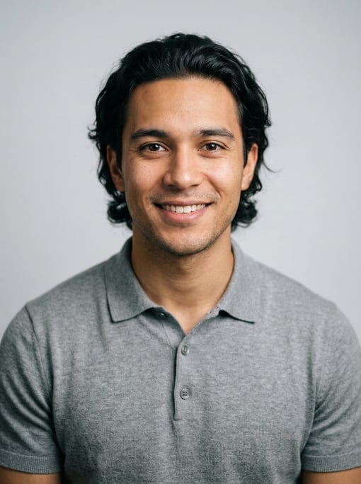 Professional studio headshot of a 25-year-old mixed-race man with medium-length wavy black hair swep