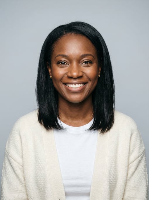 Professional studio headshot of a 36-year-old West African woman with shoulder-length straight black