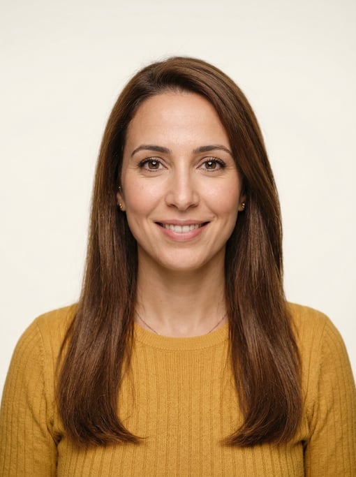 Professional studio headshot of a 34-year-old North African woman with long straight chestnut hair
