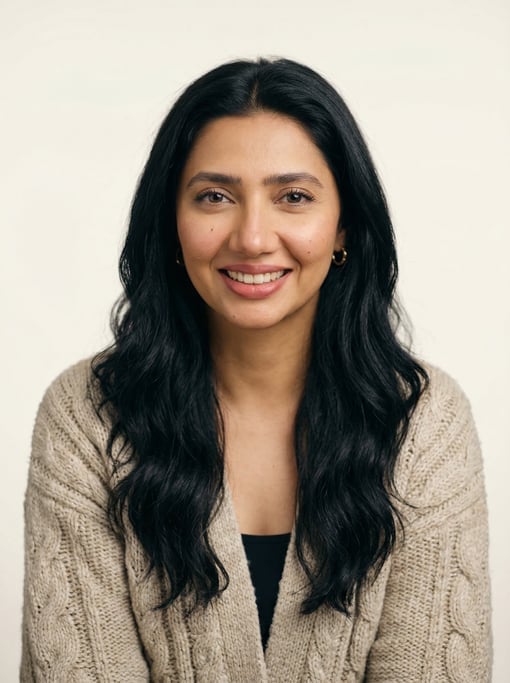 Professional studio headshot of a 30-year-old Pakistani woman with long wavy black hair