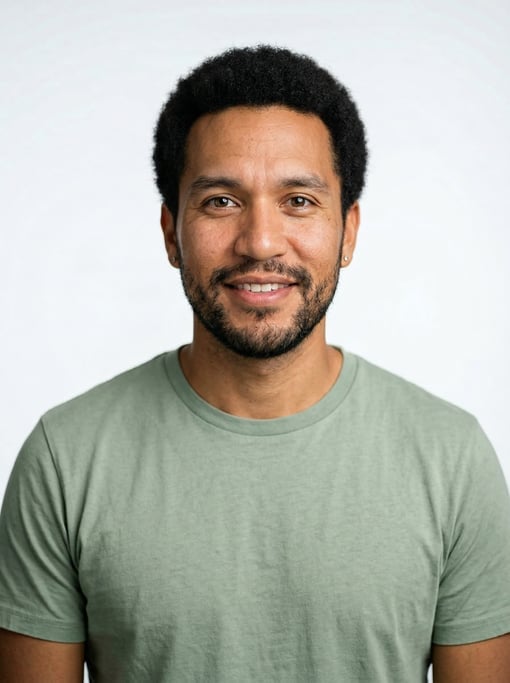 Professional studio headshot of a 32-year-old Native American man with a short natural afro in black