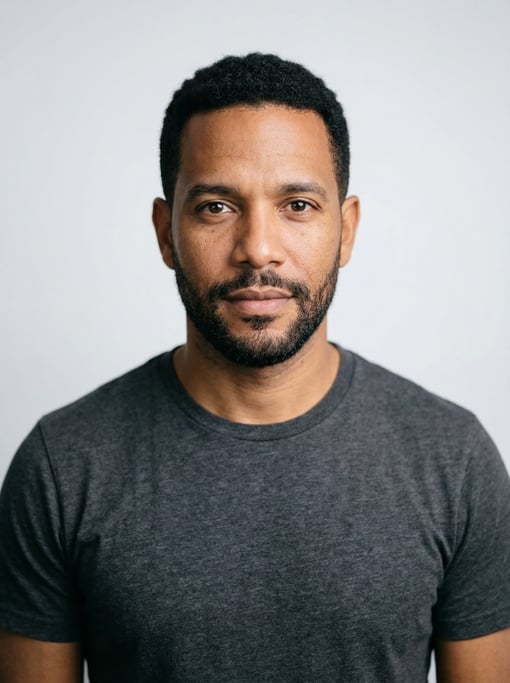 Professional studio headshot of a 39-year-old Cuban man with short cropped black hair