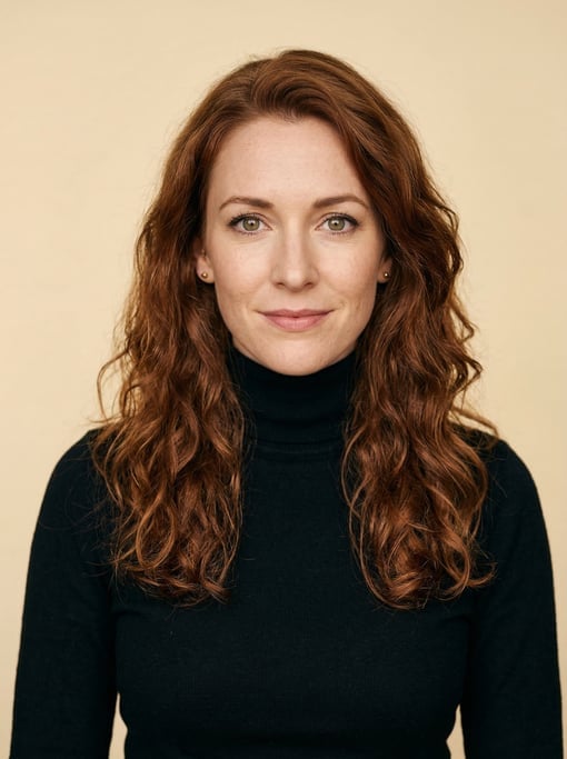 Professional studio headshot of a 32-year-old White European woman with long wavy auburn hair