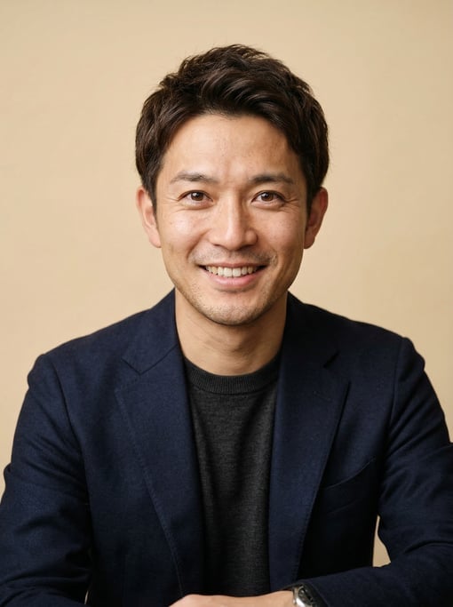 Professional studio headshot of a 33-year-old Japanese man with short textured dark brown hair