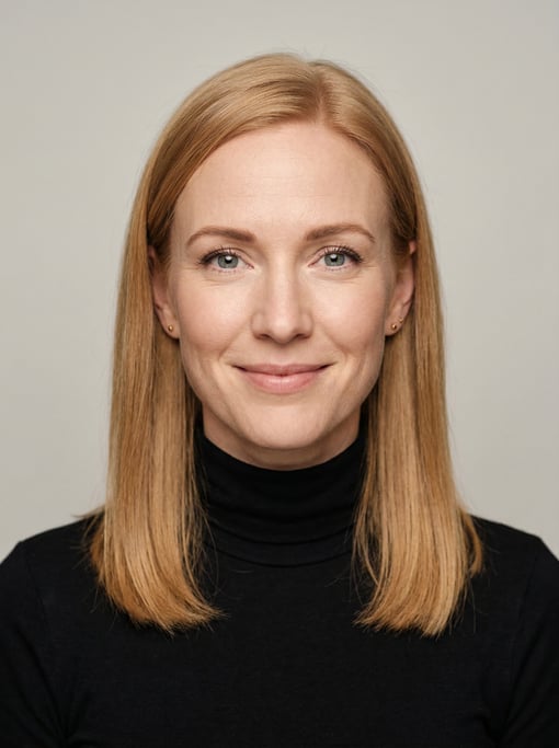 Professional studio headshot of a 36-year-old White European woman with fine straight strawberry blo