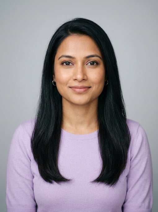 Professional studio headshot of a 32-year-old Bengali woman with long straight black hair falling pa