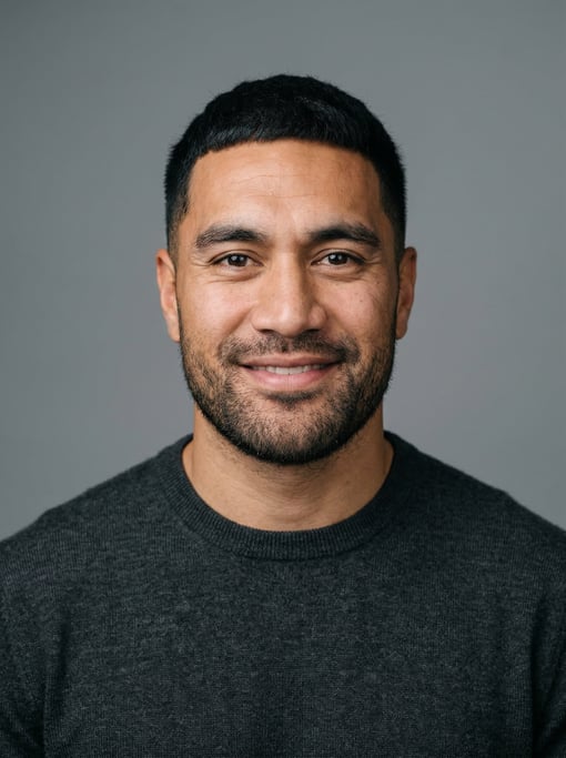 Professional studio headshot of a 31-year-old Maori man with a black textured crop