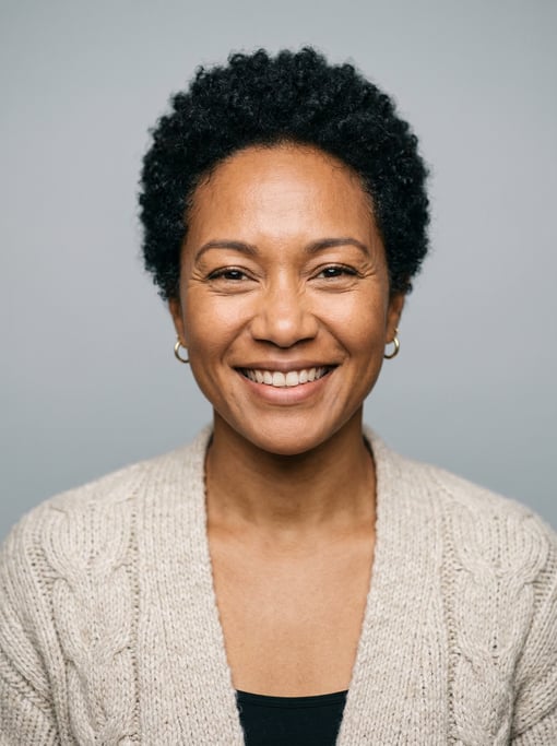 Professional studio headshot of a 38-year-old Hawaiian woman with a short TWA hairstyle in black
