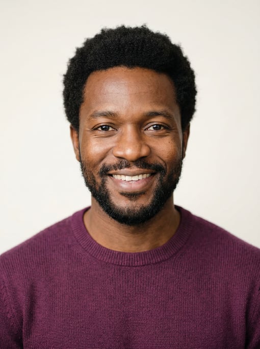 Professional studio headshot of a 36-year-old Nigerian man with a short natural afro in black