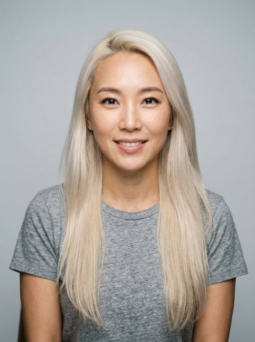 Professional studio headshot of a 36-year-old Korean woman with long straight platinum blonde hair