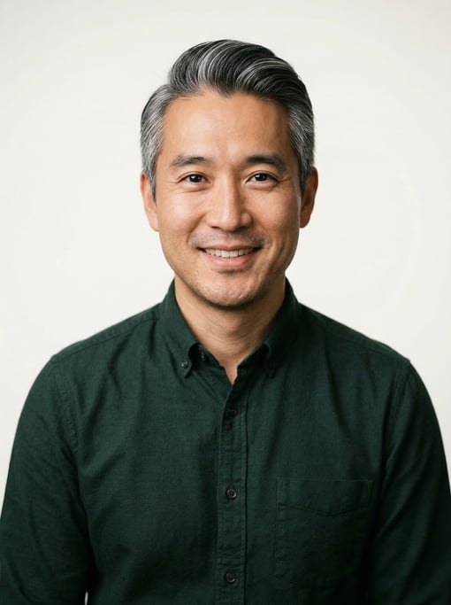 Professional studio headshot of a 38-year-old Korean man with silver-streaked dark hair combed back