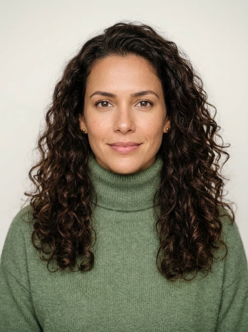 Professional studio headshot of a 36-year-old Brazilian woman with long loose curls in dark brown