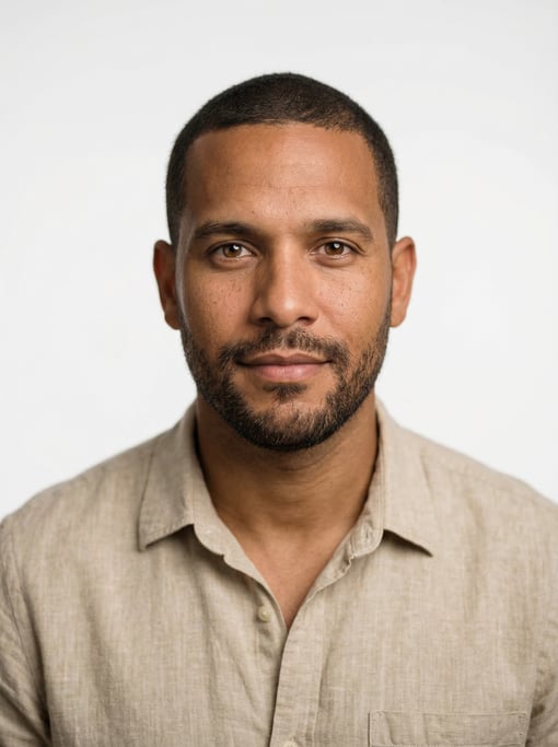 Professional studio headshot of a 32-year-old Cuban man with short cropped dark brown hair