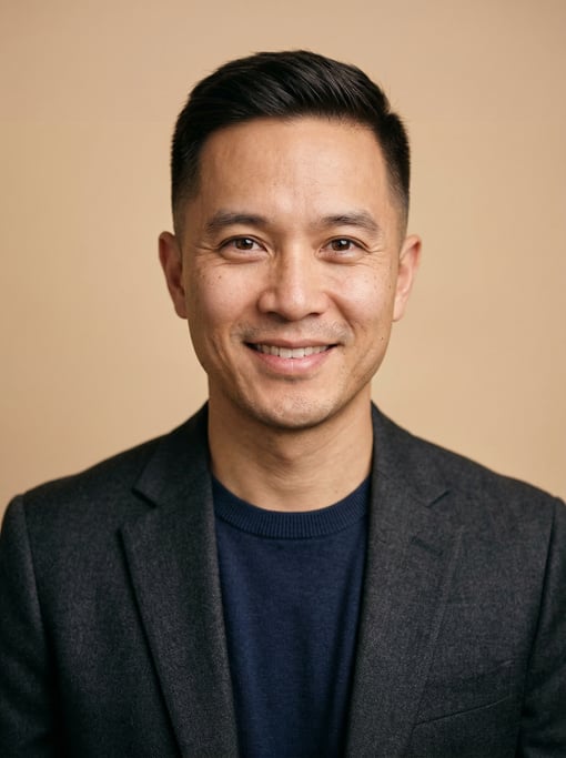 Professional studio headshot of a 35-year-old Vietnamese man with a taper fade in dark brown