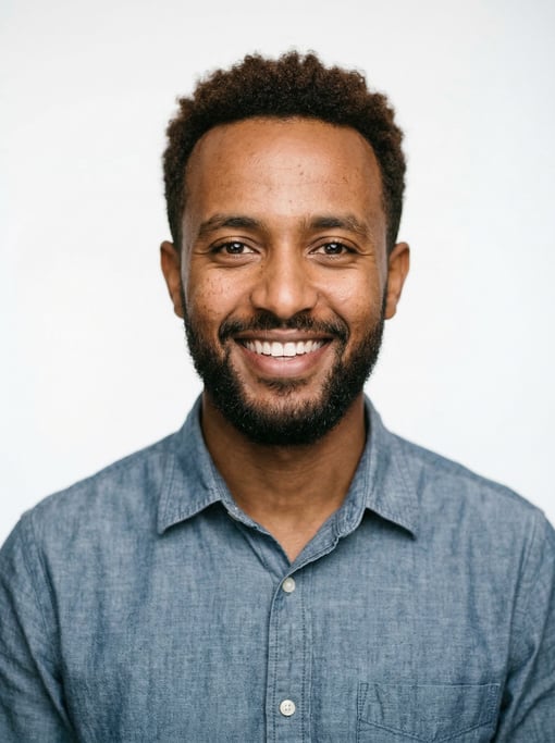 Professional studio headshot of a 24-year-old Ethiopian man with short textured dark brown hair