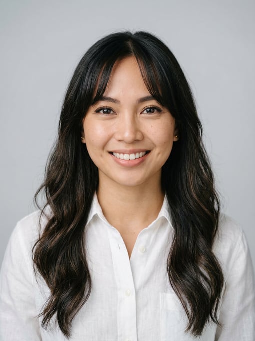 Professional studio headshot of a 26-year-old Filipino woman with curtain bangs with long dark hair