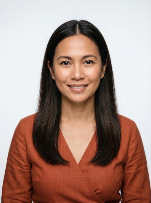 Professional studio headshot of a 40-year-old Southeast Asian woman with long straight dark brown ha