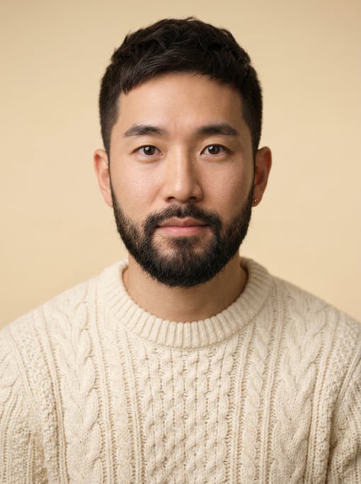 Professional studio headshot of a 29-year-old Korean man with a dark brown textured crop