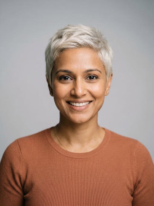 Professional studio headshot of a 35-year-old Indian woman with a short pixie cut in platinum blonde
