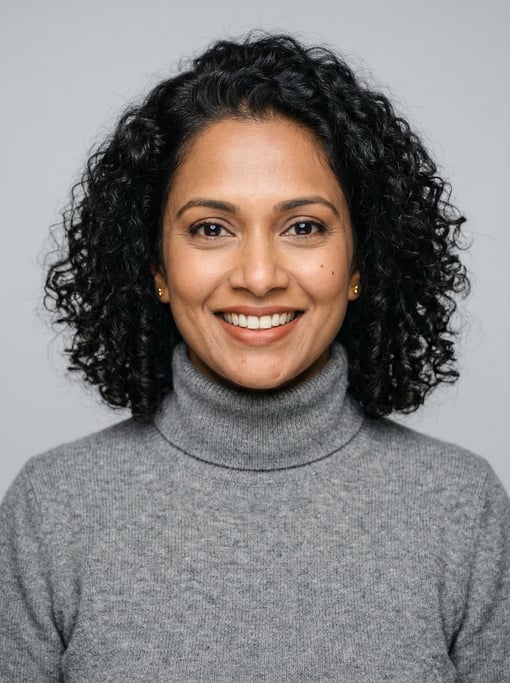 Professional studio headshot of a 39-year-old Sri Lankan woman with shoulder-length coily natural ha